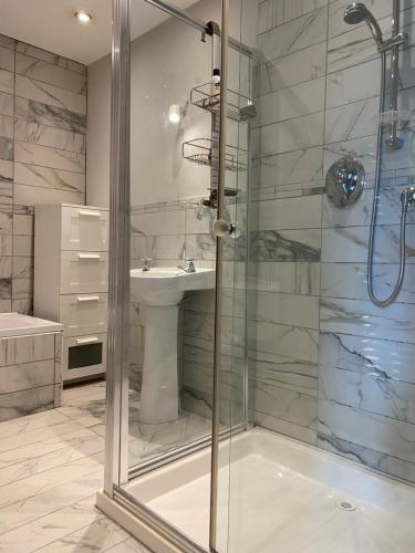 a bathroom with a shower and a sink at The Coach House at Moyglare Manor in Maynooth