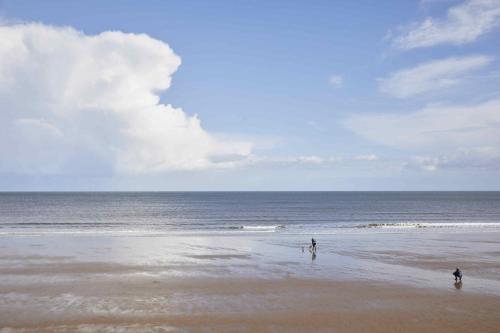 twee mensen op een strand met de oceaan bij The Cobbles in Filey
