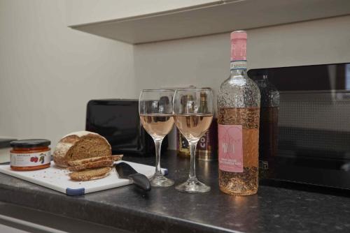 a bottle of wine and two wine glasses on a counter at The Cobbles in Filey