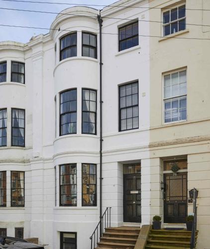 a white building with black windows at The Cobbles in Filey