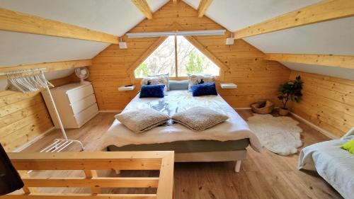 a bedroom with a large bed in a room with wooden walls at Chalet Marseille hauteur in Marseille