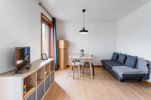a living room with a couch and a table at Coreto Apartment in Vila do Conde