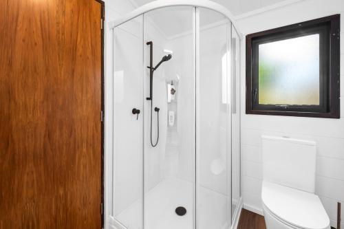 a shower with a glass door in a bathroom at Lakefront Gem - Kuratau Holiday Home in Kuratau