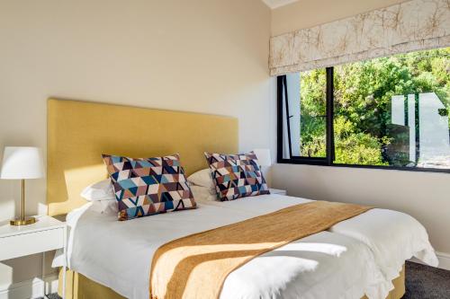 a bedroom with a large bed and a window at Ocean's Horizon Beach House in Scarborough