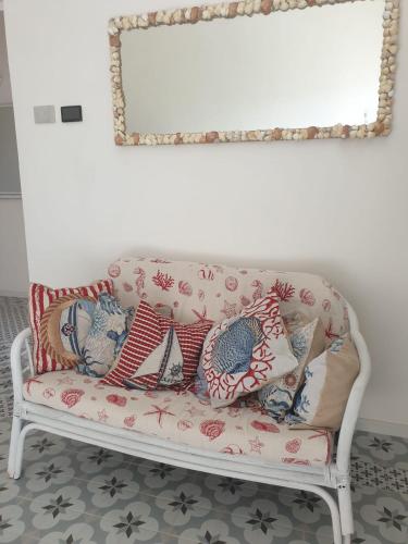 a couch with pillows on it in a living room at Dimora Quattro Vanelle in Favignana