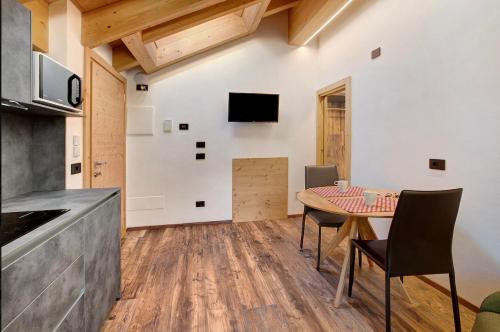 a kitchen and dining room with a table and chairs at Olympic Chalet in Bormio