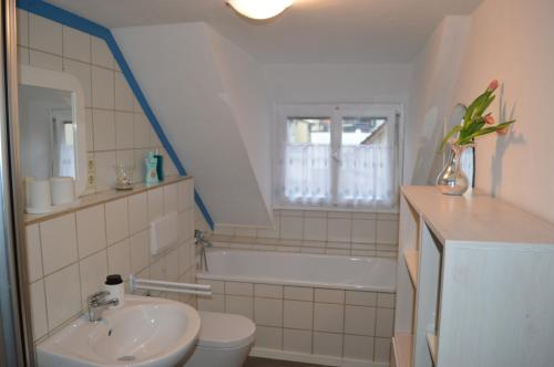 a bathroom with a sink and a tub and a toilet at Ferienwohnung Meersburg 30m vom Bodensee in Meersburg