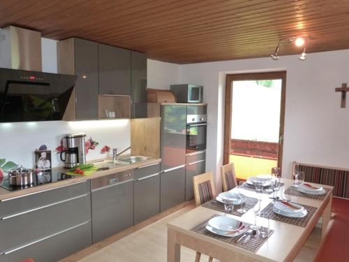 a kitchen with a table and a dining room at Haus Margret in Stummerberg