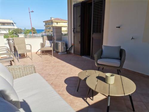 a patio with chairs and a table on a balcony at Del Gaudio Guesthouse in Torre Melissa