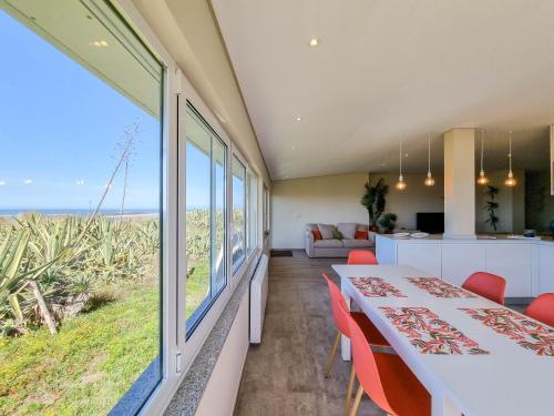 a dining room with a table and a view of the ocean at Pé No Mar - sea view in Viana do Castelo