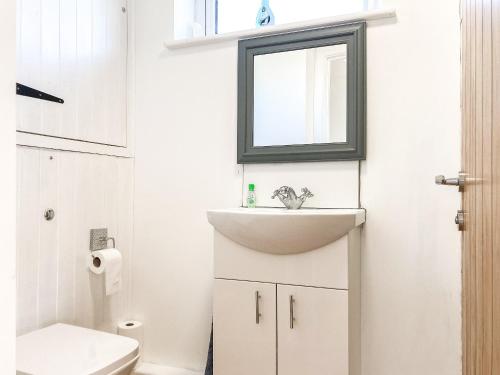 a bathroom with a sink and a toilet at Keel Annexe in Week Saint Mary