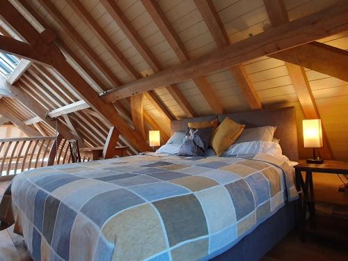 a bedroom with a large bed in an attic at Oakenhurst in Fowey