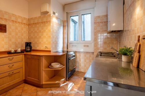 a kitchen with a sink and a stove top oven at Casa Cristina by PortofinoVip in Portofino