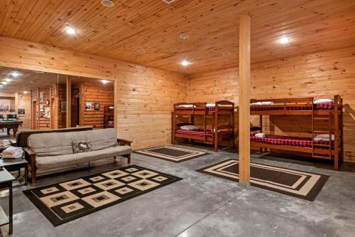 a room with bunk beds and a couch and tables at Rustic Elegance in Boone