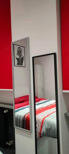 a bedroom with a bed and two mirrors at VIGEVANO LA STAZIONE in Vigevano