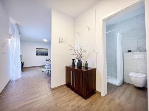 a bathroom with a toilet and a sink at Apartments Teodora Maria in Novigrad Istria