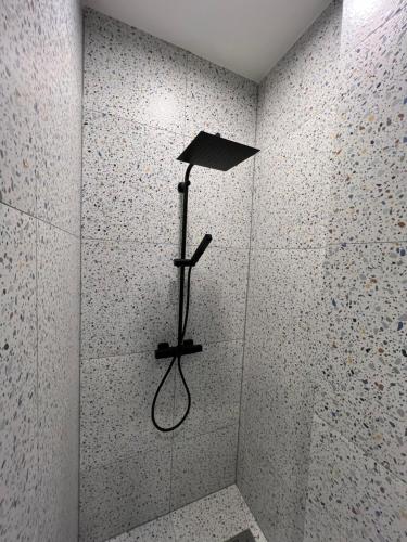 a shower in a bathroom with a shower at Comfort Hostel Klaipeda in Klaipėda