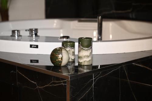 two vases sitting on a shelf next to a bath tub at Palace Eight - Suites & Spa in Cosenza