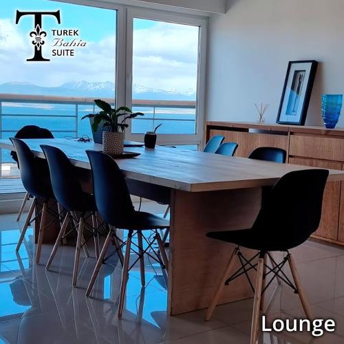 a dining room with a large wooden table and chairs at Turek Residences in Ushuaia