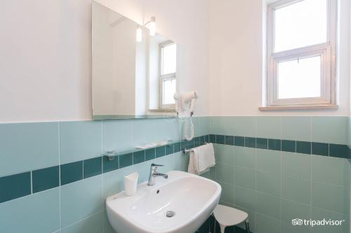 a bathroom with a sink and a mirror at Hotel Anna in Terracina