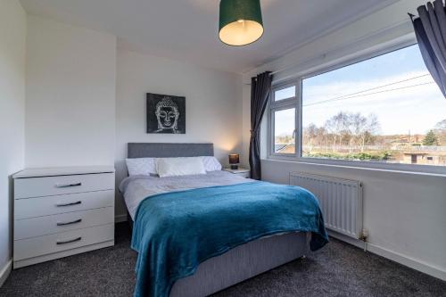 a bedroom with a bed and a large window at Gedling Contractors Delight! in Nottingham