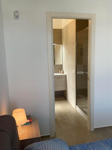 a room with a bathroom with a sink and a mirror at VILLA DALU not only Holidays in Trani