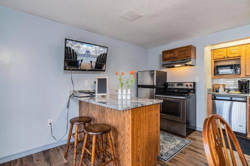 a kitchen with a counter and some stools in it at Lakeside Landing Suite in Hollister