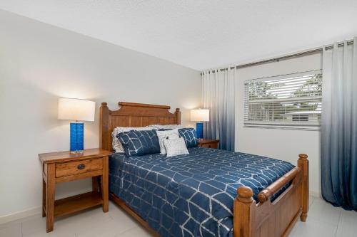 a bedroom with a blue bed and a window at Beach Luxury 805 in Naples