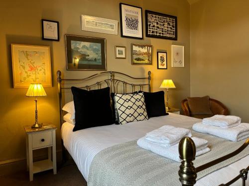 a bedroom with a bed with two towels on it at 1869 - Room Only Boutique Townhouse in Ambleside