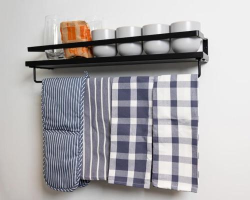 a shelf with plates and cups on a wall at Thena Hotel- Lux Studio in Philadelphia