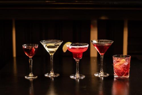 a group of four wine glasses sitting on a table at 8 Beresford Street in Saint Helier Jersey