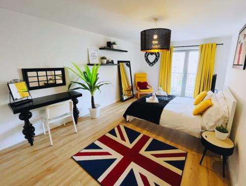 a bedroom with a king sized bed and a piano at Bristol City Stays - 1 Bed - Pembroke Court in Bristol