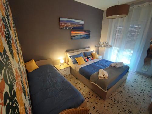 Ένα ή περισσότερα κρεβάτια σε δωμάτιο στο La mia seconda casa ad Aci Castello
