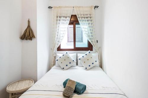 a bed in a room with a window at DAR ADIL KASBAH in Tangier