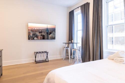 a white bedroom with a bed and a window at Thena Hotel 2nd Floor Studio Unit4 in Philadelphia