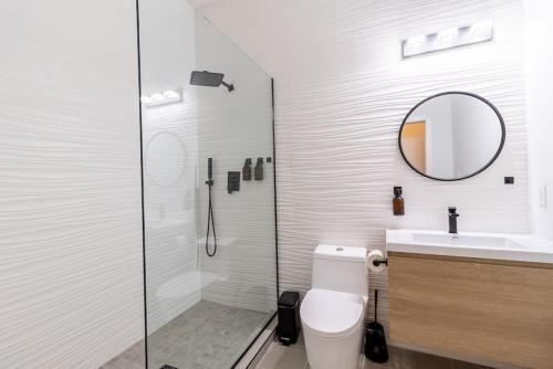 a bathroom with a toilet and a sink and a mirror at Thena Hotel 2nd Floor Studio Unit4 in Philadelphia
