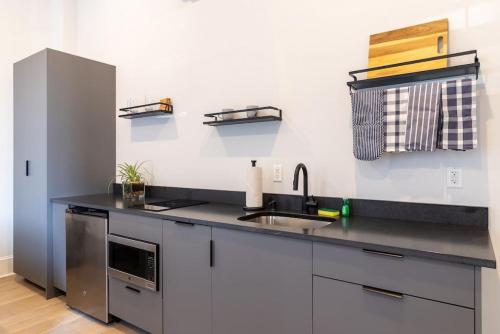 a kitchen with a sink and a counter top at Thena Hotel 2nd Floor Studio Unit4 in Philadelphia