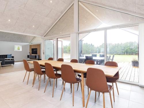 a dining room with a large wooden table and chairs at 10 person holiday home in Jerup-By Traum in Jerup