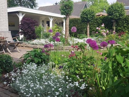 a garden with flowers in front of a house at Dajan in Almere