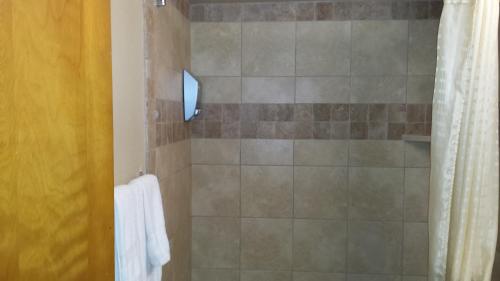 a bathroom with a shower with a shower curtain at Downtown Value Inn in Portland