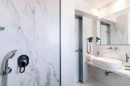 a bathroom with a shower and a sink at Hotel Lefkas in Lefkada