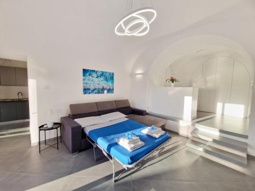 a living room with a bed and a couch at Annarosa Home in Vico Equense