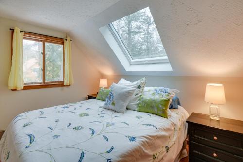 a bedroom with a bed with pillows and a window at Bartlett Vacation Rental with Wraparound Deck! in Bartlett