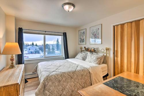a bedroom with a bed and a large window at Anchorage Vacation Rental in Walkable Area! in Anchorage
