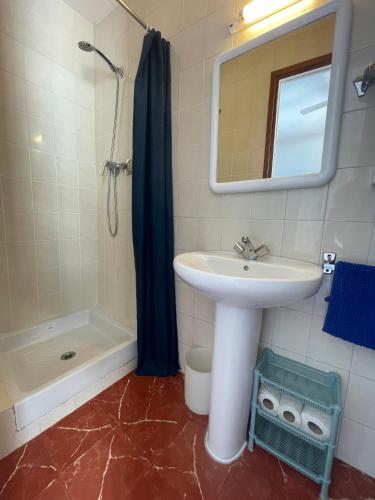 a bathroom with a sink and a shower and a mirror at P&R hostals Can Tort in Tossa de Mar