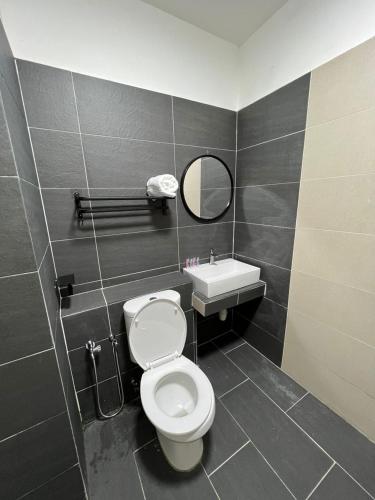 a bathroom with a toilet and a sink at HASSMA Studio Apartment at Kompleks Mutiara GM in Gua Musang