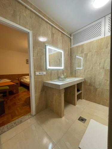 a bathroom with a sink and a mirror at Euro Panzio in Debrecen