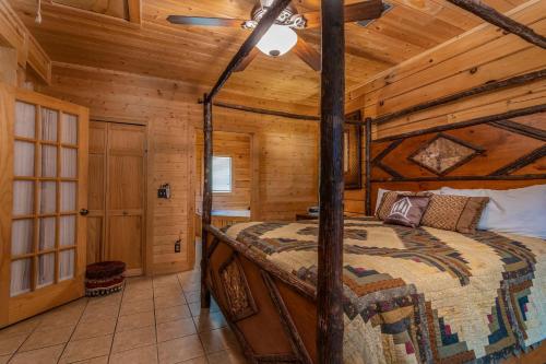 a bedroom with a bed in a wooden cabin at Ole Hickory w/Firepit HotTub in Ridgedale