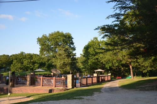 a park with a fence and trees in the background at Ole Hickory w/Firepit HotTub in Ridgedale