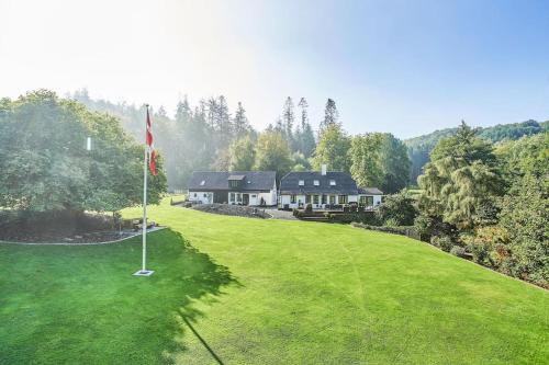 an aerial view of a house with a putting green at Naturskøn landidyl på Ibækgaarden - I egen bolig in Vejle